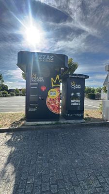 a black box with a pizza on it sitting on the side of the road