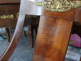 a wooden chair with a floral upholstered seat in a living room