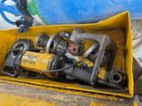 a yellow box filled with tools sitting on the ground