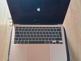 an apple laptop computer sitting on top of a wooden floor