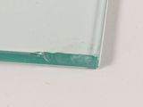 a glass plate with a green edge on a white surface