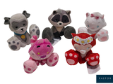three stuffed animals are sitting next to each other on a white surface