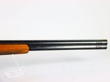 a close up of a shotgun on a white surface with a white background