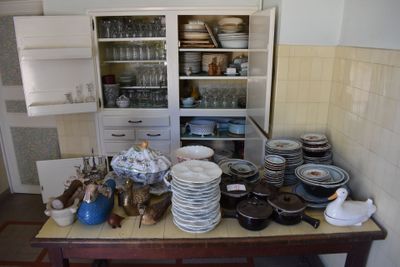 many plates and bowls on a table in the kitchen