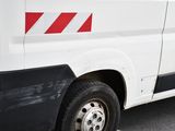 a white van with a red stripe on the side of it