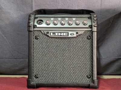 a close up of a guitar amplifier sitting on top of a red carpet