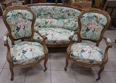 three chairs and a couch in a room
