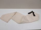 beige pants with a black label on them sitting on a white table