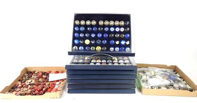 several boxes of assorted buttons are sitting on a white surface