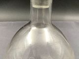 a clear glass bottle with a clear top on a table