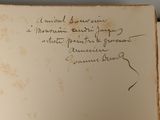 an old book with writing on it sitting on top of a table