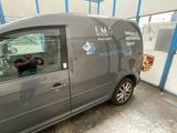 a van that is parked in a garage with the door open