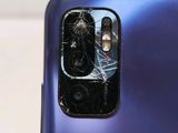 a broken glass on the back of a cell phone