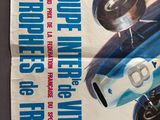 a poster of a blue race car on a table