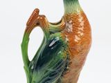 un canard en céramique perché sur une plante