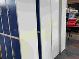 three lockers in a room with a lot of blue and white doors