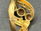 a gold ring that is on top of a table