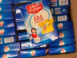 a box of soap sitting on top of a pile of blue boxes