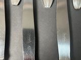 five knives that are sitting next to each other on a table