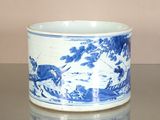 a blue and white cup sitting on top of a table