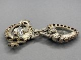 a close up of a pair of earrings on a table