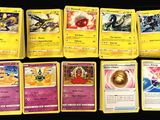 several pokemon cards are lined up on a black surface