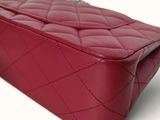 chanel red quilted leather handbag on white background