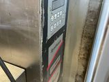 an image of a gas pump in a dirty room