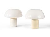two white mushroom shaped lamps sitting next to each other on a white surface