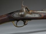 an old gun that is on display on a table
