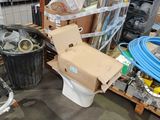 a toilet in the middle of a room with a lot of items