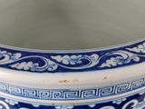 a blue and white bowl with a design on it