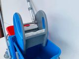 a blue bucket and a blue mop on a white table