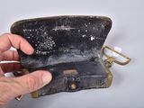a hand that is holding an old wallet