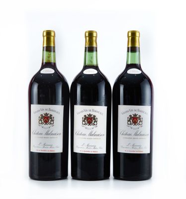 trois bouteilles de vin rouge sont alignées sur une surface blanche