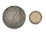 an old coin with a crown on top of it next to a smaller coin