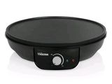 an image of a black electric skillet sitting on top of a white surface