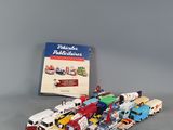 a lot of toy trucks and a book on the table