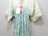 a close up of a dress hanging on a hanger on a wall