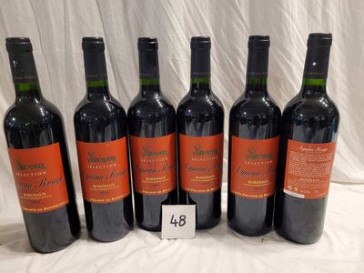 six bottles of red wine are lined up on a table