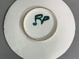 a white plate with a green design on it