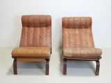 pair of mid century danish lounge chairs in brown leather