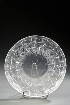 an image of a clear glass plate on a stand on a black background
