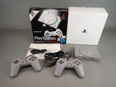 sony playstation playstation game system with two controllers and a charger