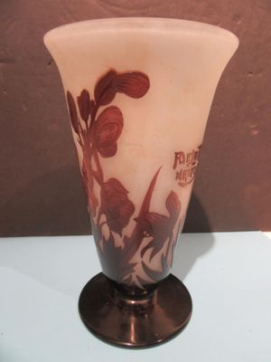 a glass vase with a design on it sitting on a table