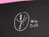 a black box with a pink ribbon on it