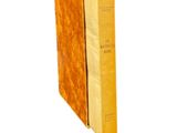 an old book with a yellow cover sitting on top of a white surface