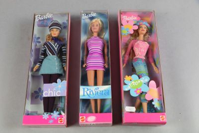 three barbie dolls are in a box on a table