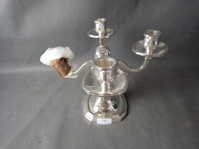 a silver candelab with two candles on top of it