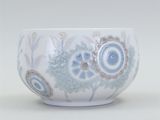 a white bowl with blue and brown designs on it